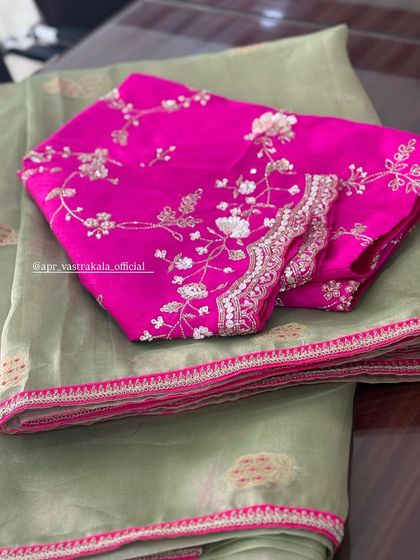 The full view of the pink blouse with silver embroidery.