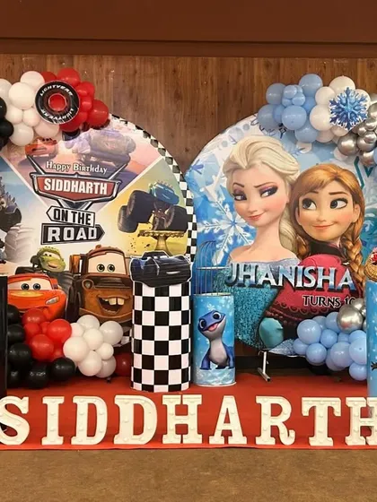 I can create unique combined themes for shared parties, like this "Cars" and "Frozen" setup for twins. Each side has its own distinct characters and color scheme, united by balloon arches and personalized name displays.