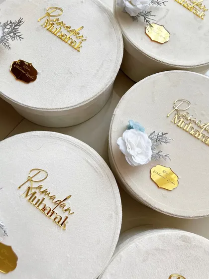 A top-down view of the velvet Ramadan hampers, each with a personalized gold tag.