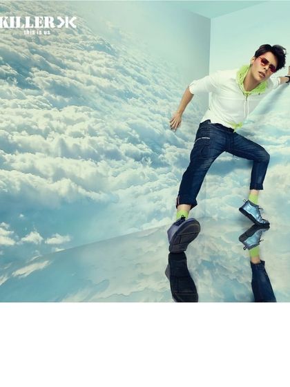A surreal concept for Killer Jeans, where the model is styled in a clean, modern look inside a room made of clouds. The reflection adds a disorienting, dreamlike quality to this fashion-forward campaign.
