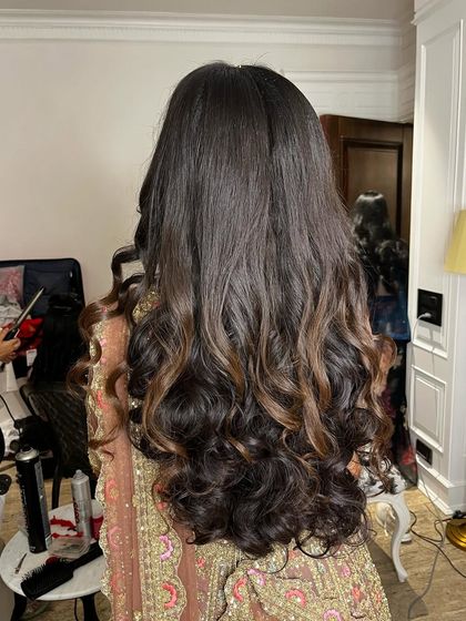 The back view of these rhythmic tresses, a perfect symphony of style for a Sangeet night.