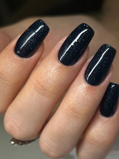 A deep, sparkling black polish on square-shaped gel extensions. The subtle glitter within the dark base adds a touch of glamour and dimension.