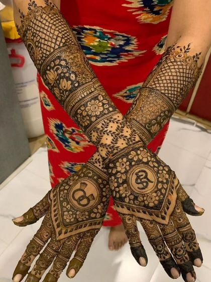 A closer look at the hands from the initialed bridal set, showing the intricate floral and net patterns.