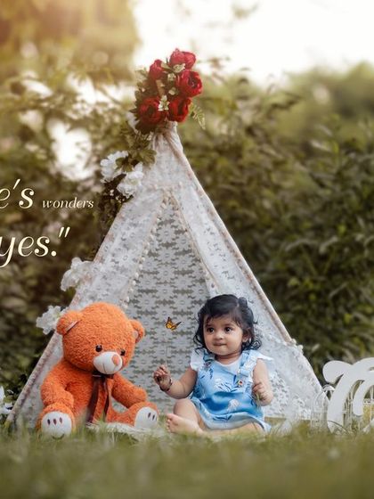 A sweet moment between a little girl and her teddy bear in front of a lace teepee. This outdoor portrait captures the innocence and comfort of childhood friendships.
