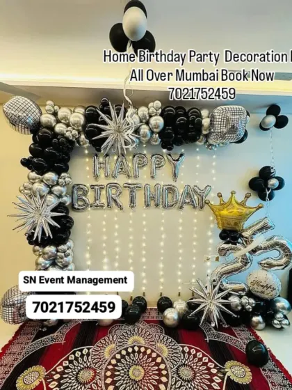 A glamorous black and silver home decoration. This setup features a full balloon frame, starburst foil balloons, and a light-up curtain for a dazzling birthday party.