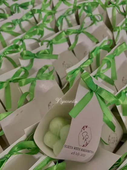 Another angle of the baby bubble candles with custom packaging. The cone-shaped box is a unique way to present a small and thoughtful wedding favor.