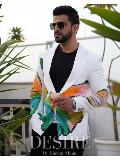 This white blazer with vibrant floral and butterfly prints is for the modern man who isn't afraid to stand out. It’s a bold look that exudes confidence.