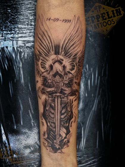 A guardian angel in full armor, designed as a symbol of protection. The intricate details on the armor and wings were created using fine needles and careful shading to give it a metallic, textured look.