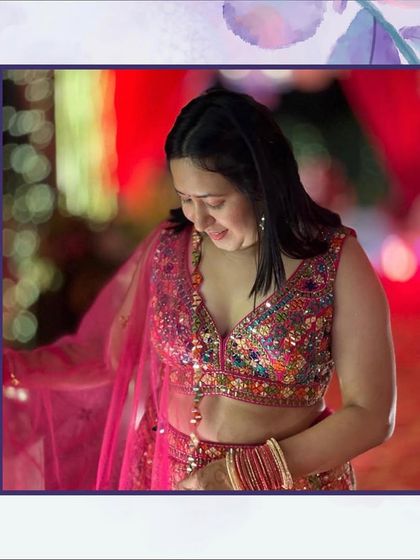 A client looking lovely and radiant in a multi-colored blouse and pink lehenga. Her happiness is my goal.