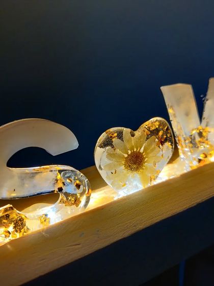 I can even preserve flowers from your wedding day inside a custom resin name stand. This one uses flowers and pearls from a varmala, set in a wooden base with an LED light.