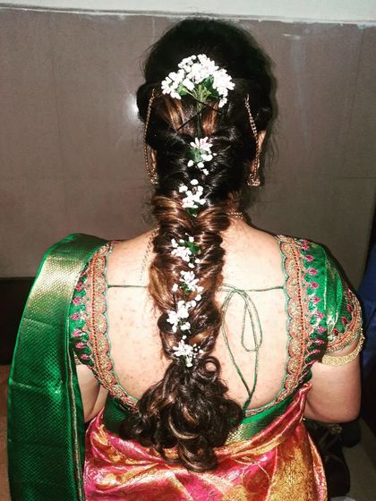 A duplicate image of the romantic messy braid with baby's breath.