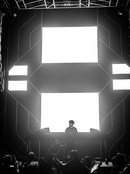 A dramatic black and white shot of me on the massive stage at Sunburn Union, framed by the giant LED screens.