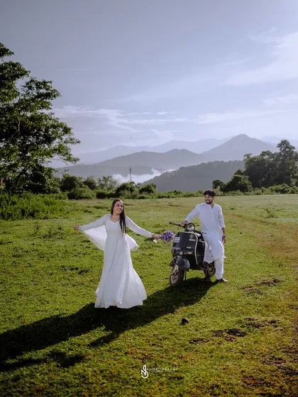 A wide, scenic shot that captures the feeling of freedom and adventure, with the couple and their scooter in a vast, beautiful landscape.