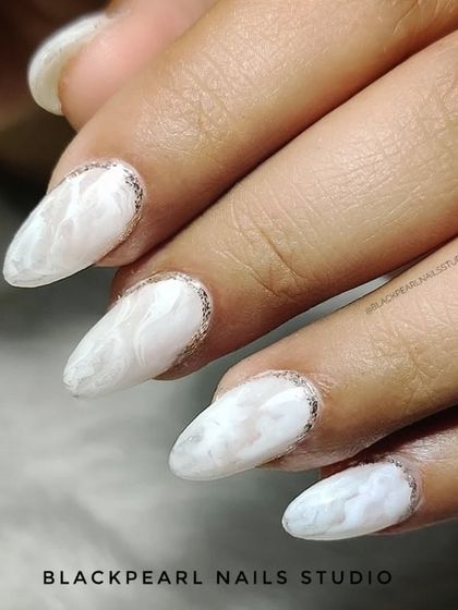 A stunning set of opal marble nails with a glittery reverse French. This design mimics the multi-tonal, iridescent quality of an opal stone, creating a truly eye-catching and fashionable look.