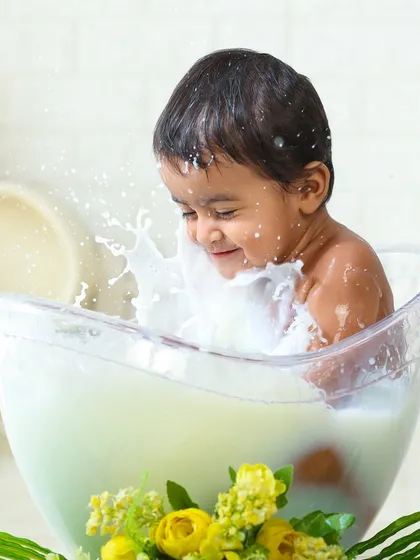 Who says bath time can't be a photoshoot? This milk bath session is one of my most creative offerings, capturing the pure, uninhibited fun of a playful splash.