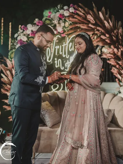 The perfect backdrop for a perfect moment. The 'Written in the Stars' neon sign and pampas grass arch I designed created a romantic setting for the ring exchange.