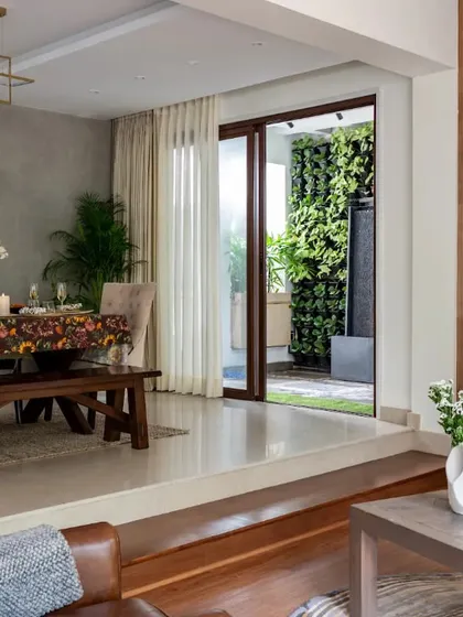 Here, we demonstrate how to create a seamless connection between indoor and outdoor living. The dining area opens directly onto a patio with a lush vertical garden, effectively extending the living space and bringing the calming presence of nature right into the home.