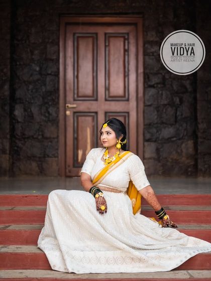 A regal pose from our haldi bride Priya. Her white lehenga with yellow accents is a unique and elegant choice for the ceremony.