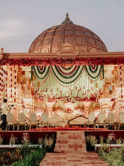 The full view of the monumental temple-style stage, designed to look like a grand palace facade, complete with a domed roof and intricate detailing.