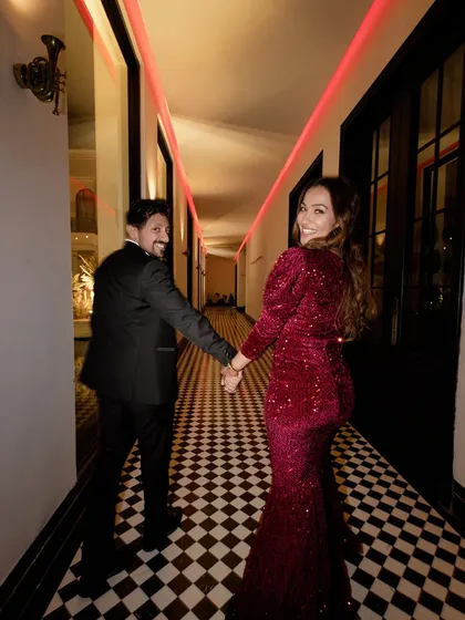 "Follow me to the party!" A fun shot of the couple leading the way to their reception, full of excitement for the night ahead.