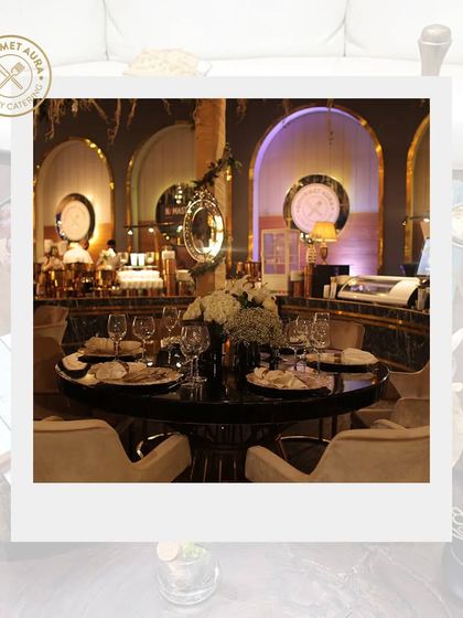 An elegant dining table setup within a grand, beautifully designed event space.