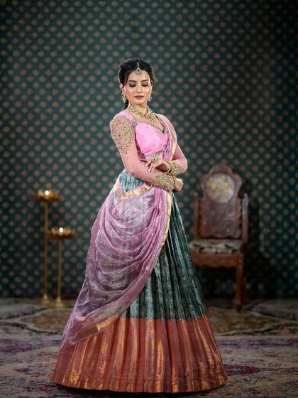 A different pose in the half-saree, showcasing the draping and flow of the fabric.