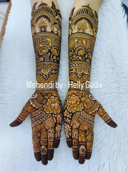 This full-arm design for a bride is a garden of flowers. It features bold, shaded roses on the palms and intricate floral bands that extend all the way up the arms.
