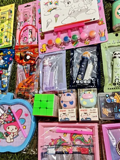 This photo shows another angle of my diverse Kanjak and return gift collection. You can spot Rubik's cubes, mini paint sets, and various character themed items all in one place.