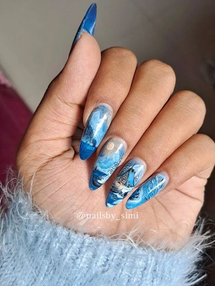 A different take on Christmas nails. This set features a hand-painted winter canvas art scene across long stiletto nails, creating a unique and artistic festive look.