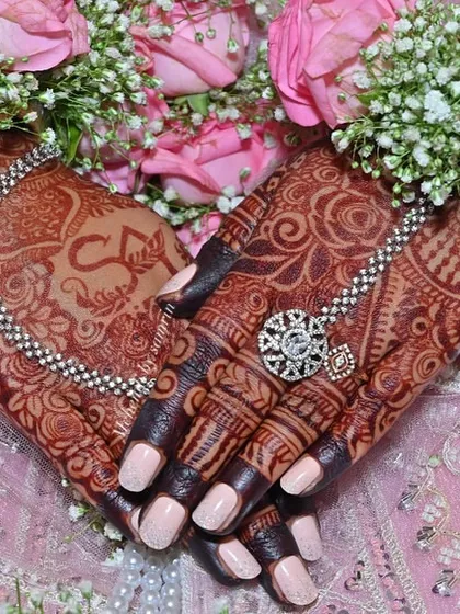 This is the result I live for. A gorgeous, deep henna stain on my bride's hands, perfectly complemented by her floral jewelry. I use only organic henna to ensure you get this rich, beautiful color for your special day.