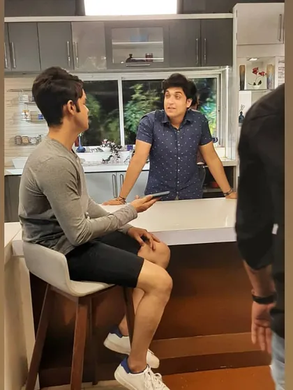 Rehearsing a scene in the kitchen set. Every moment, even the ones between takes, is about staying in character and being ready for action.