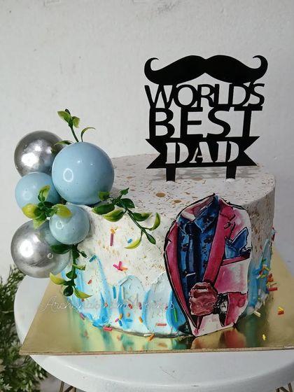 A stylish cake for the "World's Best Dad," with a cool color palette and a mustache topper.