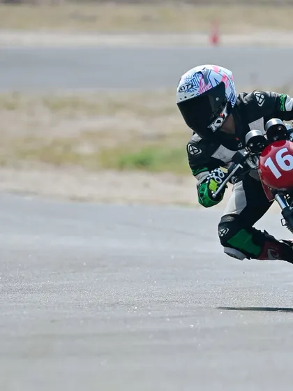 A rider leans into a corner during a track school session, practicing the techniques taught by our coaches.
