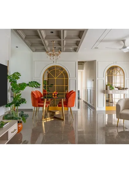 The repetition of the arched mirror motif creates a strong visual rhythm and a sense of grandeur. This view shows the seamless transition from the TV area to the dining space.