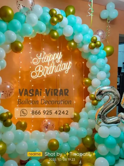 Celebrating a 25th birthday in style. This modern setup features a chic balloon ring in sea green and gold, a custom neon sign, and marquee numbers, perfect for creating a sophisticated and memorable party vibe for adults.
