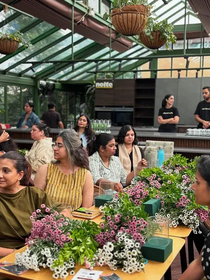 Participants fully engaged in our hands-on tablescaping workshop. Our glasshouse provides the perfect, inspiring backdrop for learning the art of table styling and setting with intention.