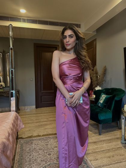 A full-length shot of the pink satin dress in my bedroom. The color looks beautiful against the neutral decor.