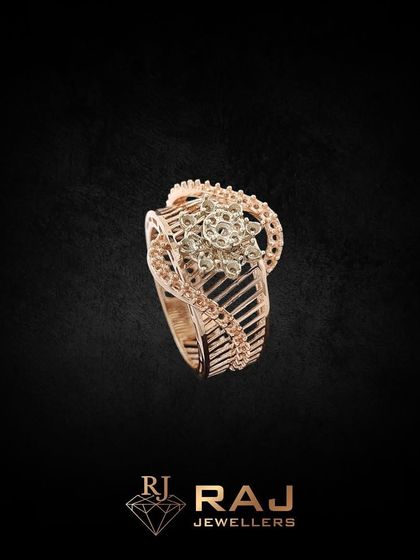 This intricately designed cocktail ring features a floral centerpiece with a detailed, openwork band. Crafted in rose gold and CZ, it is a beautiful piece of wearable art.