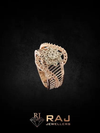This intricately designed cocktail ring features a floral centerpiece with a detailed, openwork band. Crafted in rose gold and CZ, it is a beautiful piece of wearable art.