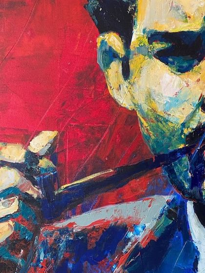 A detail shot of the red Guru Dutt painting. The focus here is on the hand and pipe, showing the expressive brushwork and color blending up close.