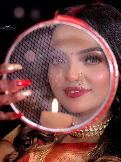 For us, photography is about creative storytelling. This Karwa Chauth shot, framed through the traditional sieve with the diya's flame, creates a unique and intimate portrait that is full of cultural significance and emotion.