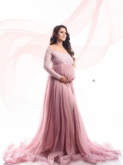 An elegant portrait in a dusty pink gown with delicate lace sleeves. The added fabric flow effect creates a sense of movement and grace against the clean white background.