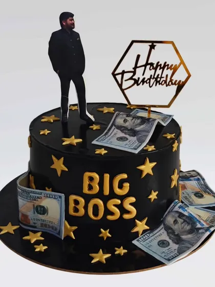 A "Big Boss" themed cake in black and gold. This whipped cream cake is decorated with edible money and stars, perfect for celebrating a husband's success.