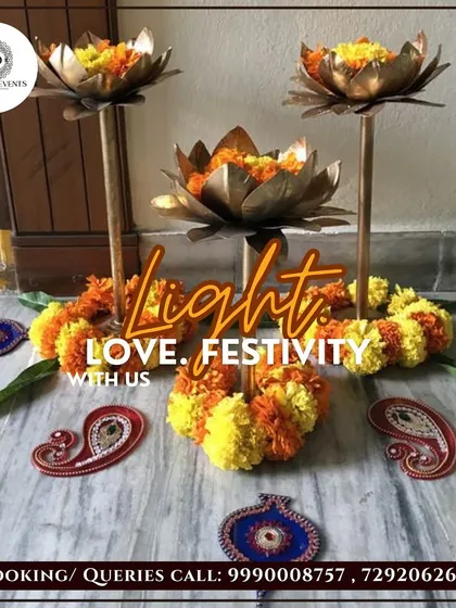 I use elegant and traditional decor pieces to enhance the festive feel. These tall, lotus-shaped brass stands filled with marigolds, paired with paisley-shaped floor decor, create a beautiful and auspicious focal point.