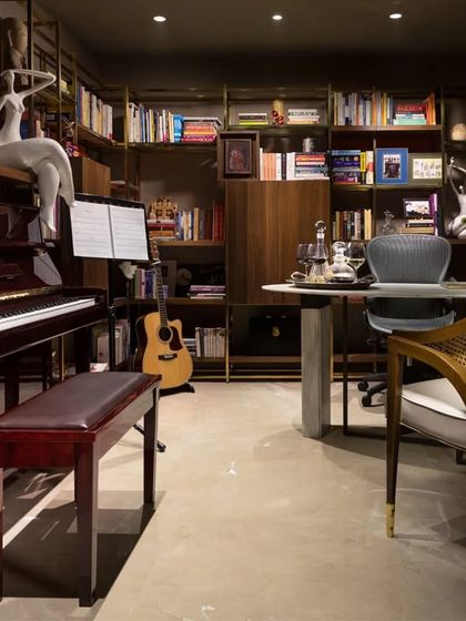 The study and music room in the Caitriona apartment is a space that reflects the owner's passions. A grand piano, a curated bookshelf, and a comfortable desk create a perfect environment for both work and creative pursuits.