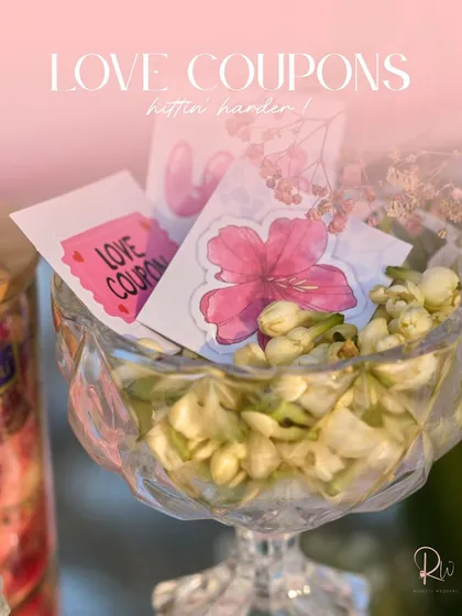 A crystal bowl filled with fresh jasmine buds and custom "love coupons." I love adding sensory details like fragrance to enhance the guest experience.