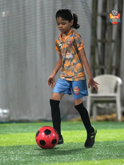 A young girl practices her dribbling, demonstrating the progress she has made in our program.