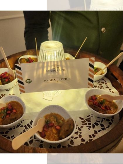 Our Ragda Pattice served in individual portions. The warm pea curry is topped with a crispy potato patty and garnished with pomegranate, a perfect bite-sized snack.