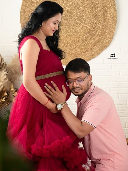 Listening for the first flutters. I love capturing these intimate moments where a partner connects with the baby bump, feeling the life growing inside. It's a memory you'll both treasure.