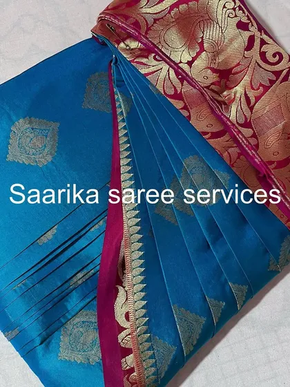 A sky blue saree with a pink and gold border, perfect for daytime events.